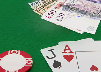 An image of a blackjack casino table with cash and chips
