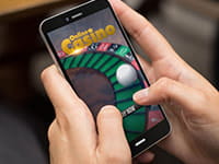 Person playing at an online casino on a mobile